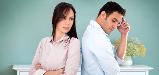 Picture of frustrated couple, back to back, who are in crisis