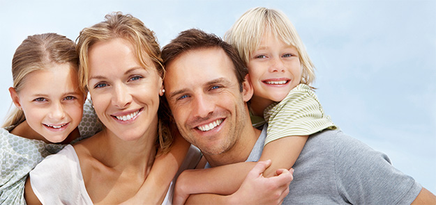 Picture of a happy mom, dad, son and daughter on a sunny day